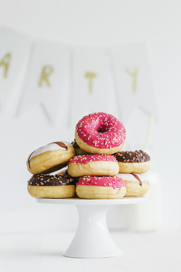 Donuts With Different Glazes On A Cake Stand Photograph by Valeria ...