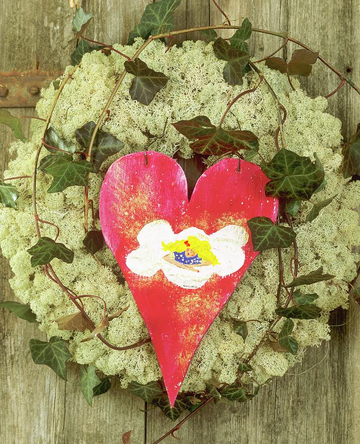 Door Wreath Of Iceland Moss, Ivy And Red Wooden Heart Photograph by Friedrich Strauss