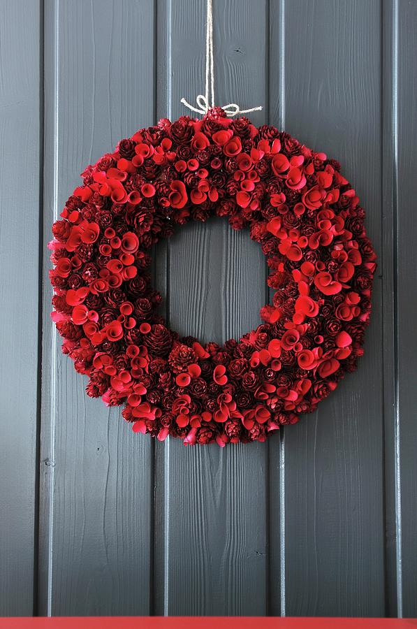 Door Wreath Of Red Pinecones And Curled Wood Shavings Photograph by Veronika Studer