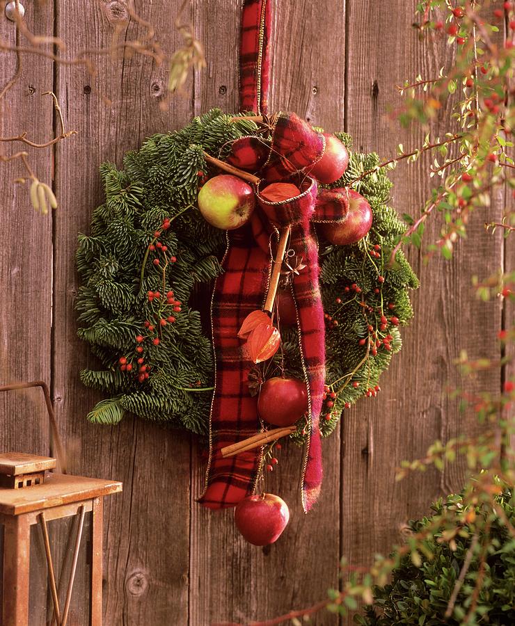 Door Wreath With Noble Fir, Rose Hips And Ornamental Apples Photograph by Friedrich Strauss