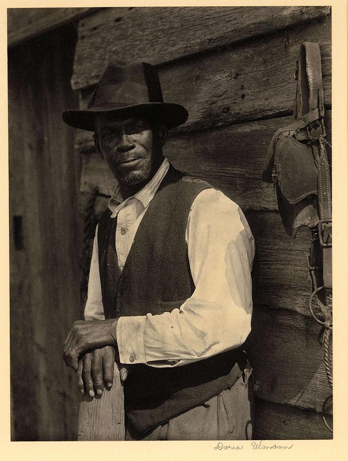 Doris Ulmann   1882-1934 , Bearded Black Man In Hat And Vest, Standing With Hands On Post, In Front Painting