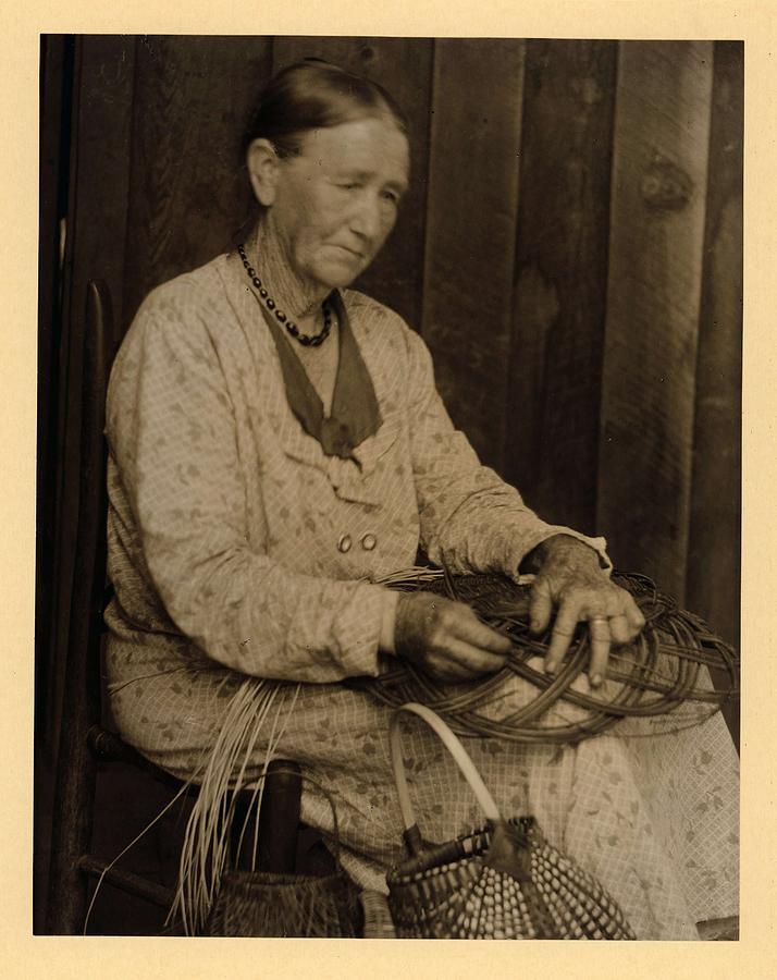 Doris Ulmann   1882-1934  Elderly Woman In Dress And Necklace, Seated In Chair, Making Basket With Painting