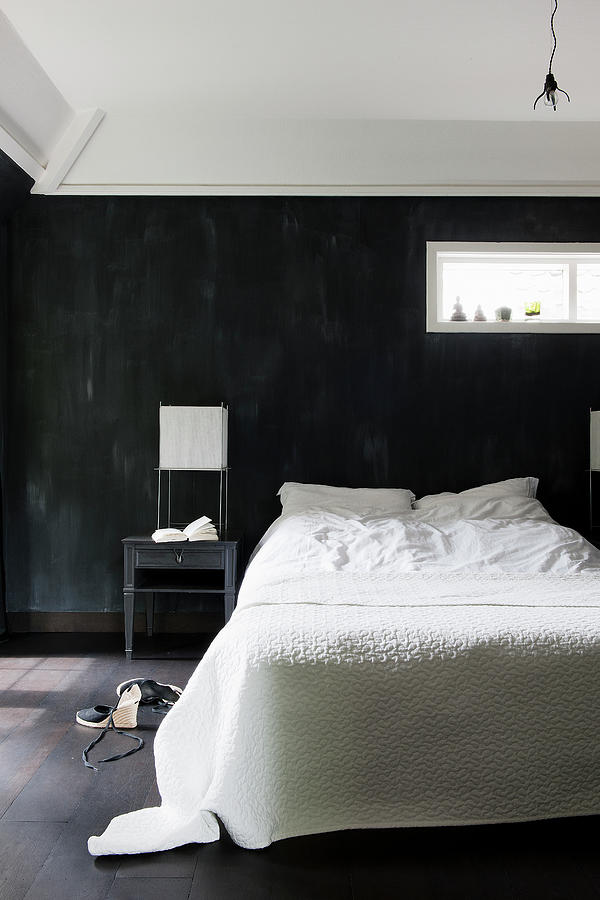 Double Bed With White Bed Linen Against Black Wall Photograph by James Stokes