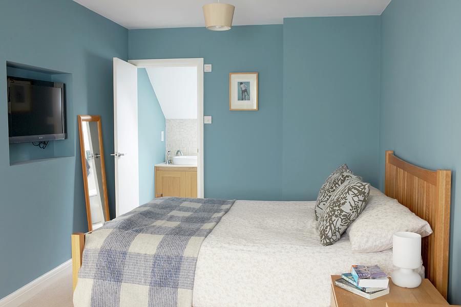 Double Bed With Wooden Headboard In Bedroom With Blue Walls An Door Leading Into Bathroom Photograph by Tim Imri