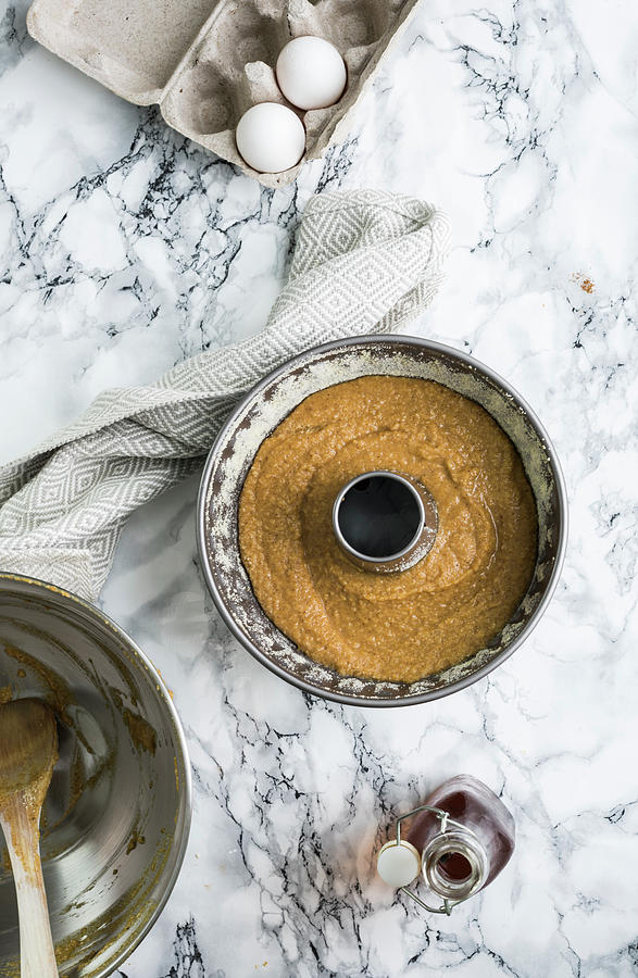 Dough In A Baking Tin For A Pumpkin And Almond Ring-shaped Cake Photograph by Healthylauracom