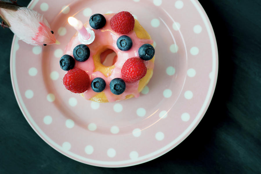 Doughnut Decorated With Fresh Berries And Birthday-cake Candle Photograph by Ulla@patsy