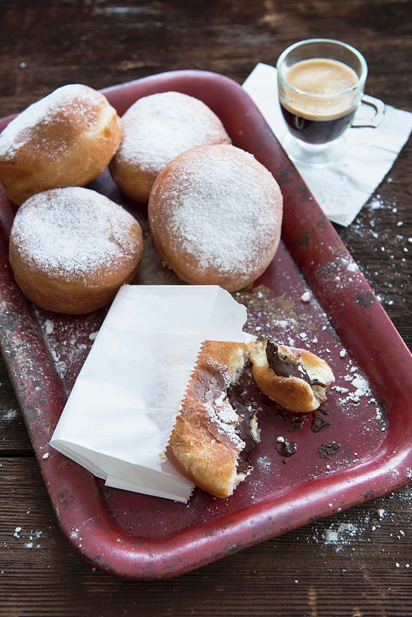 Doughnuts With Icing Sugar And A Pain Au Chocolat, Served With Coffee Photograph by Veronika Studer