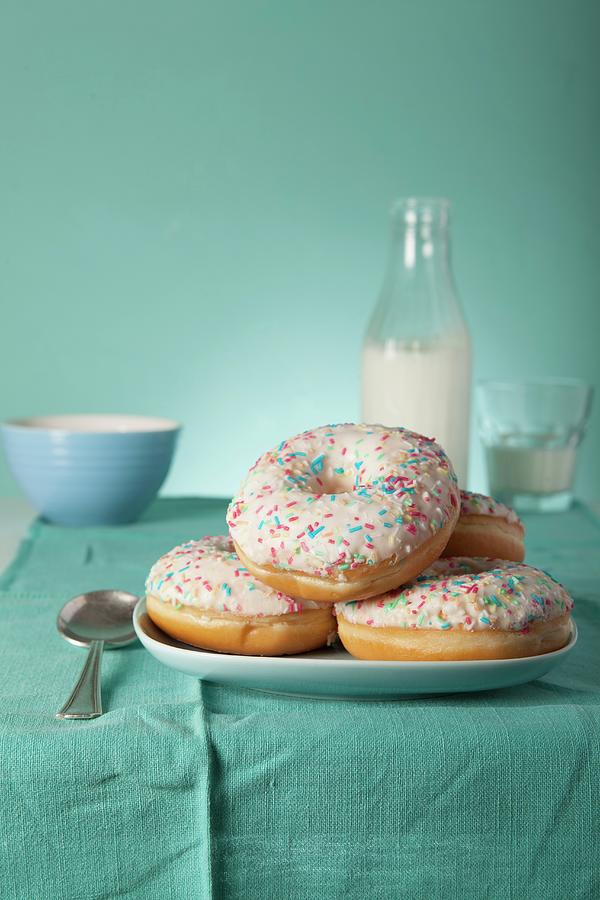 Doughnuts With Icing Sugar And Colourful Sugar Sprinkles Photograph by Blueberrystudio