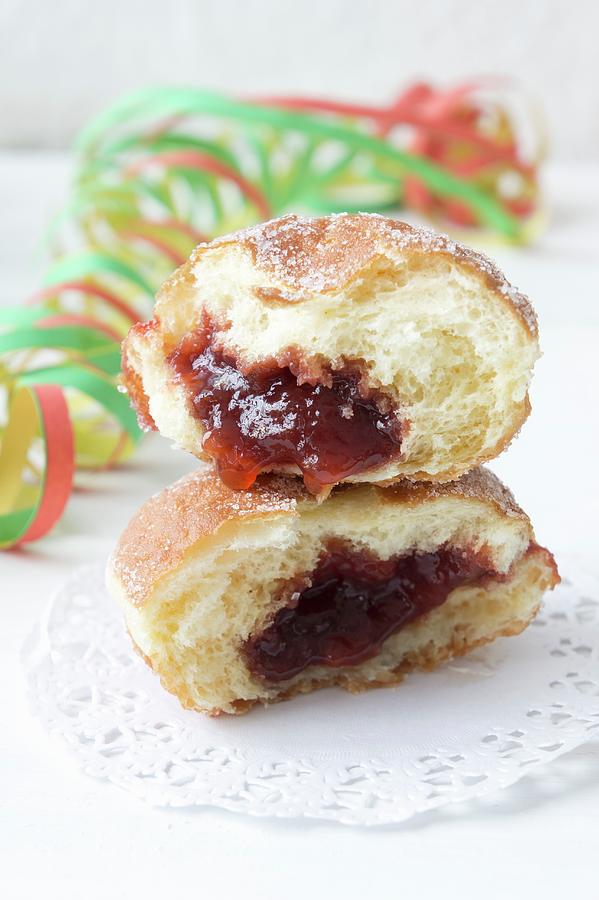 Doughnuts With Jam On Paper Doilies Photograph by Martina Schindler