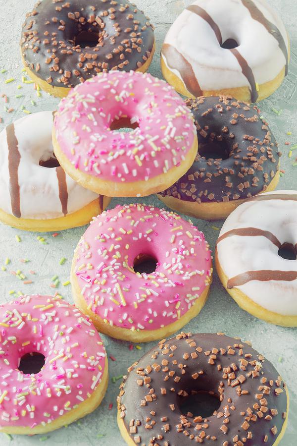 Doughnuts With Various Glazes And Sugar Sprinkles Photograph by Jan Wischnewski