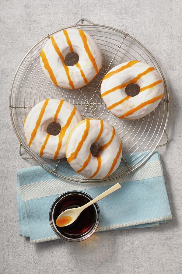 Doughnuts With White Glaze And Caramel Sauce Photograph by Jean-christophe Riou