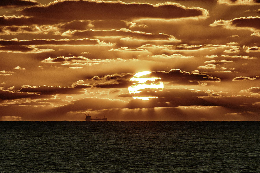 Dramatic Atlantic Sunrise with Ghost Freighter in Goldtone Photograph by Bill Swartwout