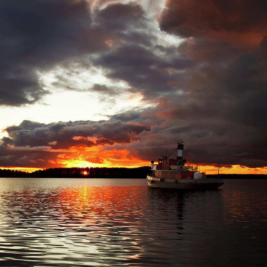 Dramatic Sunset And Small Boat Photograph by Barry Madden Photography