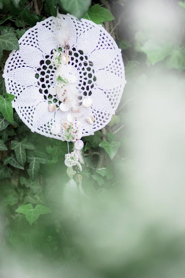 Dreamcatcher Made From Lace Doily Hung Amongst Ivy Photograph by Bildhbsch