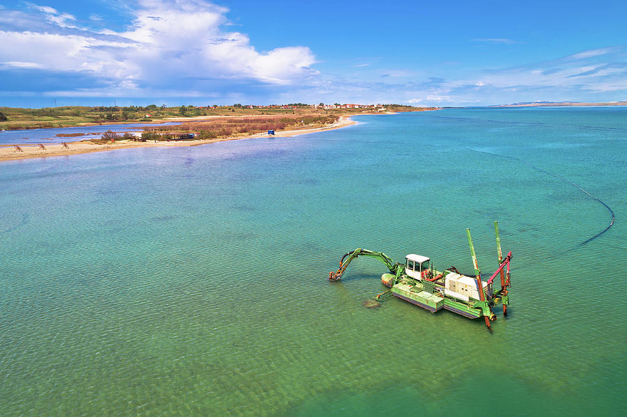 Dredger boat excavating sand for beach in shallow water near tow Photograph by Brch Photography