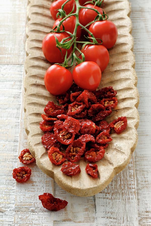 Dried And Fresh Cherry Tomatoes In A Wooden Bowl Photograph by Petr Gross