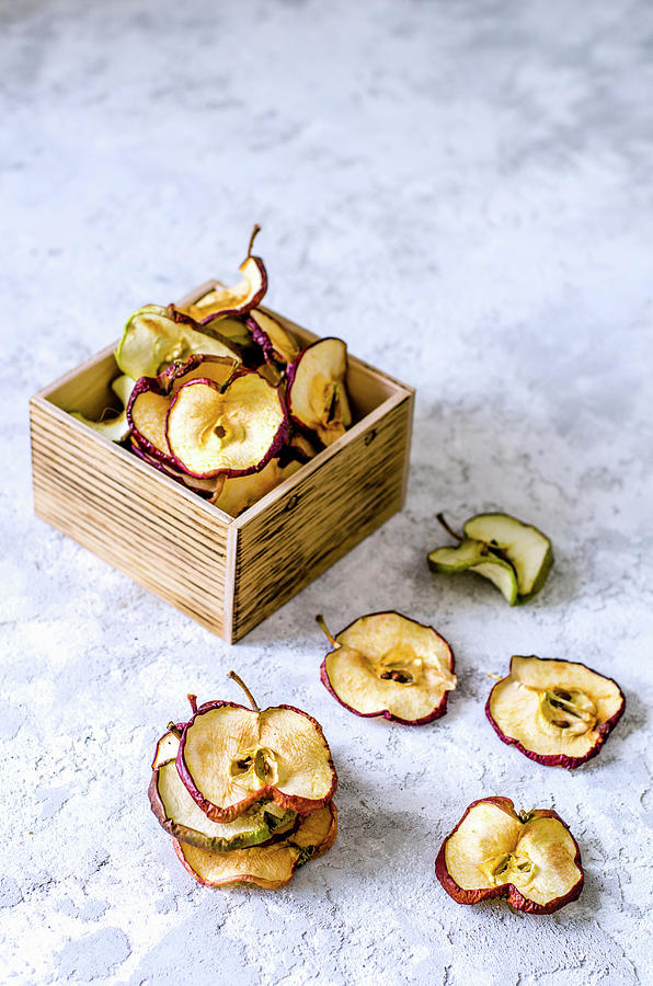 Dried Apple Chips In A Wooden Box Photograph by Gorobina