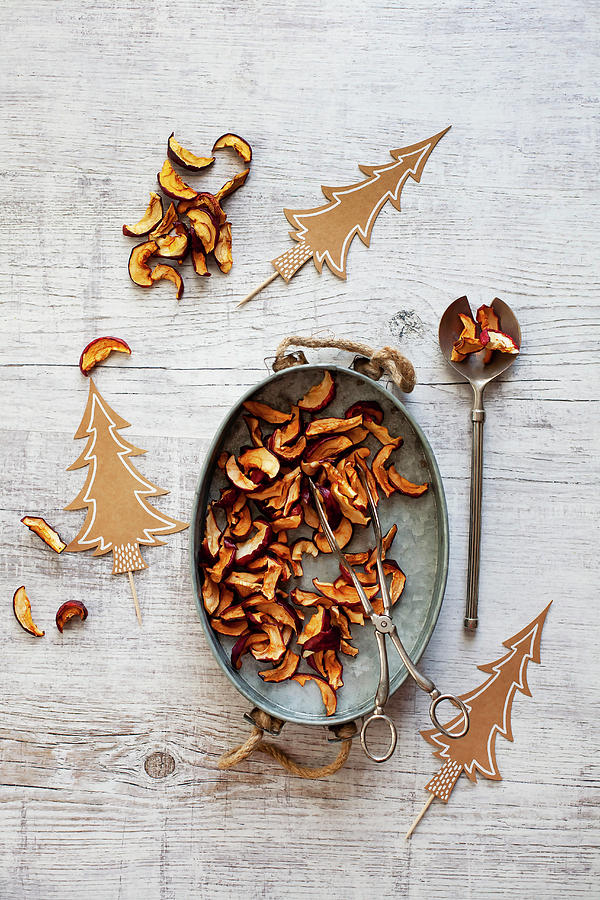Dried Apple Slices On A Zinc Tray With Christmas Decorations Photograph by Alicja Koll