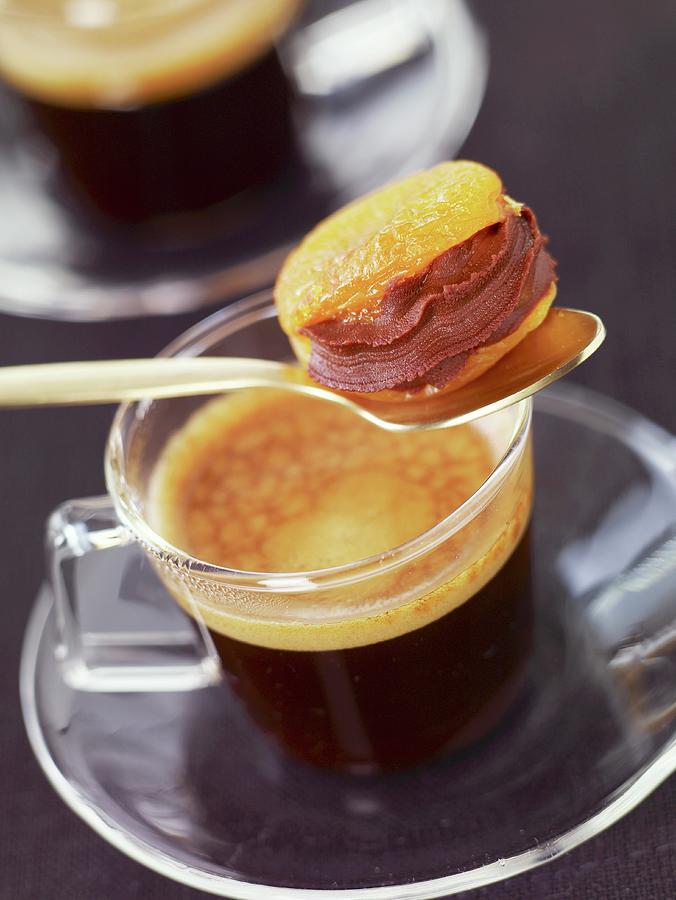 Dried Apricot With Chocolate Filling And A Cup Of Coffee Photograph by Fondacci-markezana