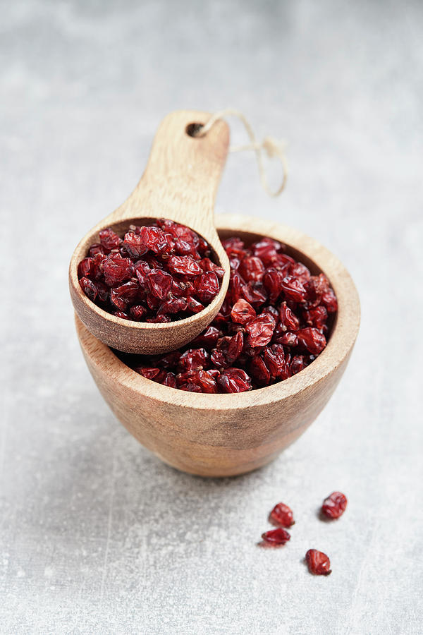 Dried Barberries In A Wooden Bowl And A Wooden Scoop Photograph by Brigitte Sporrer