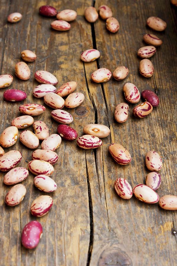 Dried Borlotti Beans On A Wooden Surface Photograph by Larissa Veronesi Fine Art America