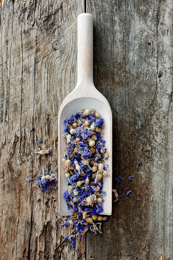 Dried Cornflowers On A Wooden Scoop Photograph by Petr Gross