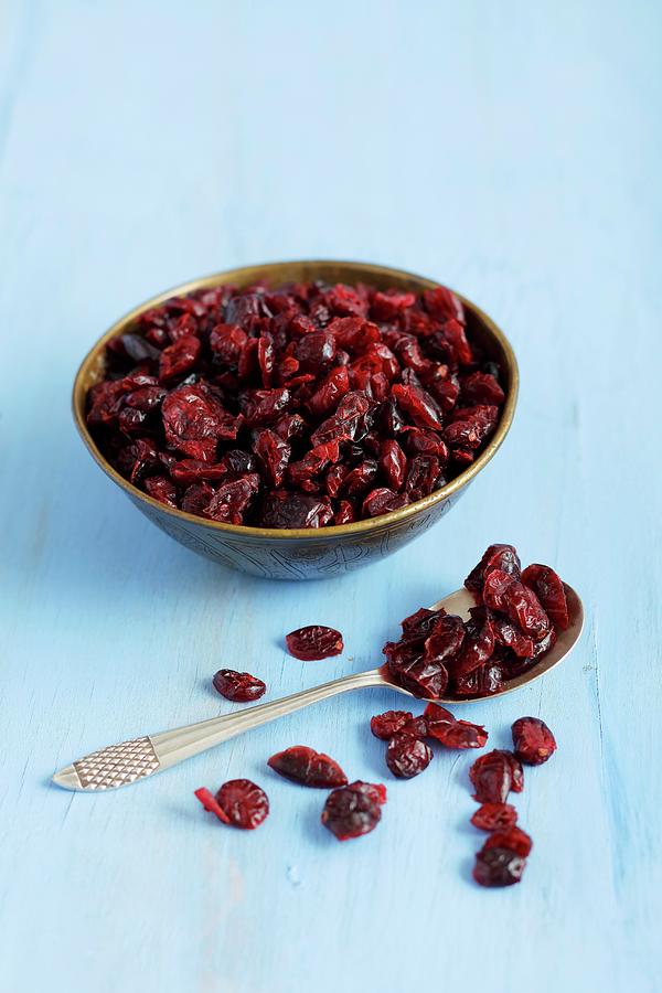 Dried Cranberries In A Bowl And On A Spoon Photograph by Rua Castilho