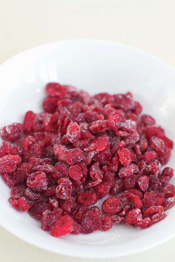 Dried Cranberries In A White Bowl Photograph by Ev Thomas