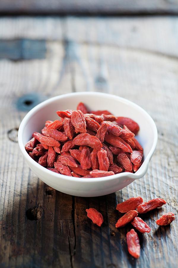 Dried Goji Berries In A Bowl Photograph by Victoria Firmston