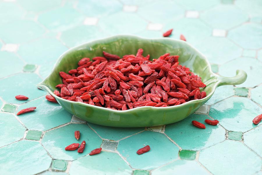 Dried Goji Berries In A Leaf-shaped Dish Photograph by Petr Gross