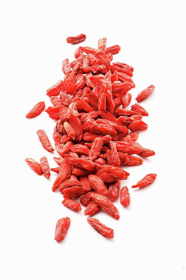 Dried Goji Berries On A White Surface Photograph by Petr Gross