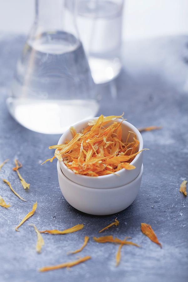 Dried Marigold Petals In A Little Bowl Photograph by Foodcollection
