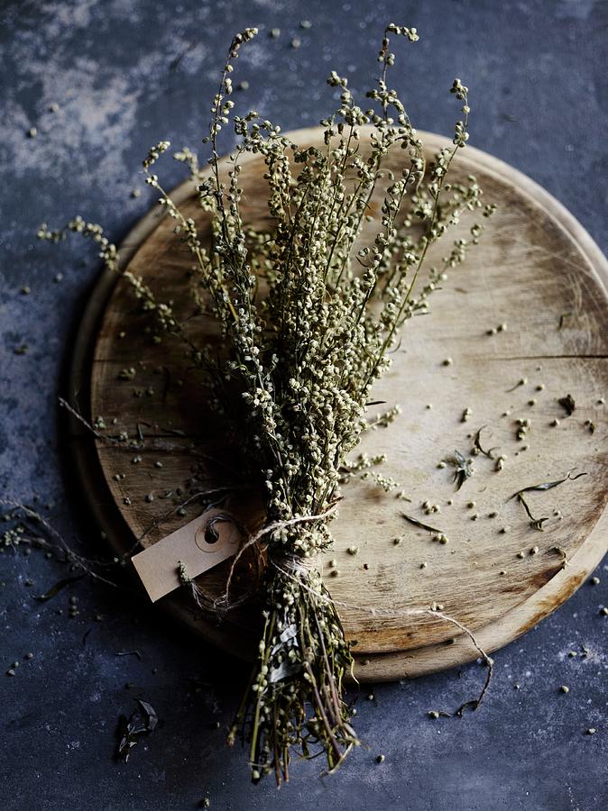 Dried Mugwort, Tied In A Bunch With A Label, On A Wooden Plate Photograph by Oliver Brachat