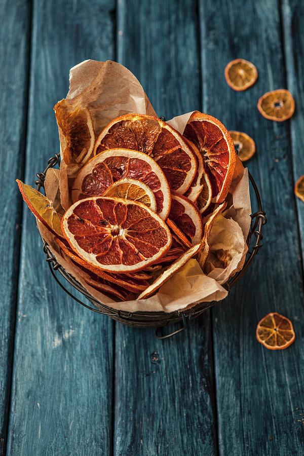 Dried Orange Slices In A Wire Basket Photograph by Nika Moskalenko