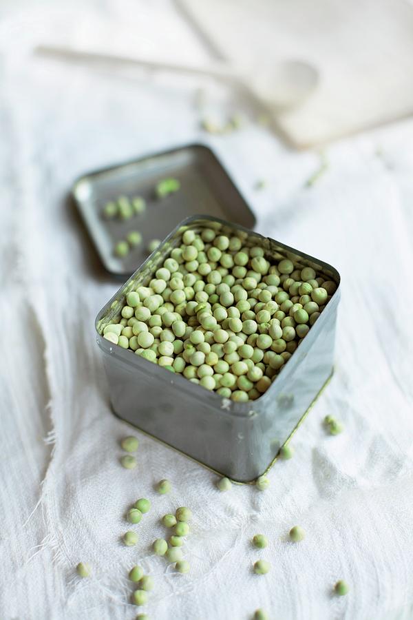 Dried Organic Peas In A Small Tin On An Old Linen Cloth Photograph by Sabine Lscher