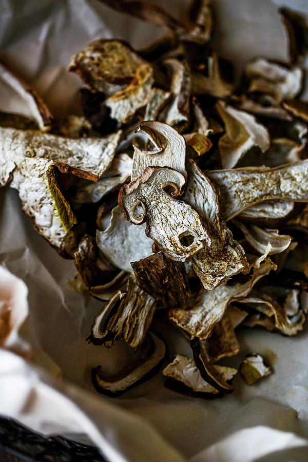 Dried Porcini Mushrooms On Crumpled Paper Photograph by Sandra Krimshandl-tauscher