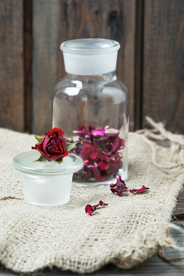 Dried Rose Petals In A Glass Jar Photograph by Mandy Reschke