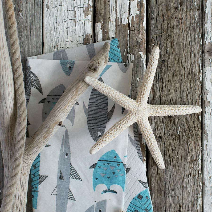 Dried Starfish, Driftwood & Napkin With Maritime Print On Weathered Wooden Surface Photograph by Sonia Chatelain