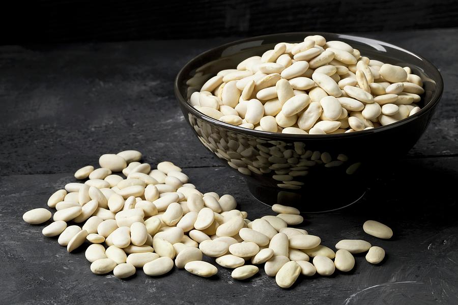 Dried White Beans In A Bowl And On A Black Surface Photograph by Shawn Hempel