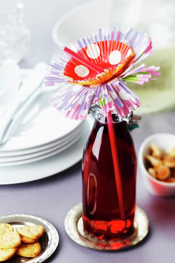 Drink In Bottle With Drinking Straw And Flower Made From Paper Cake Cases Photograph by Franziska Taube