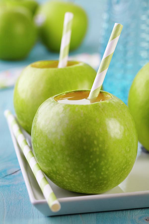 Drinking Straws In Green Apples Used As Cups Photograph by Franziska Taube