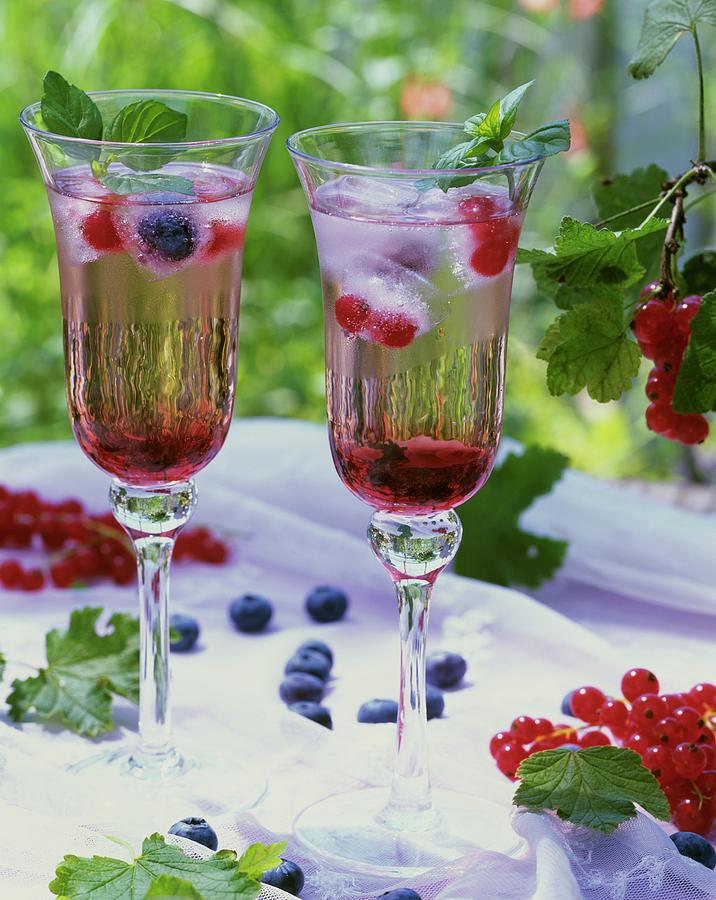 Drinks With Redcurrant Syrup And Berry Ice Cubes Photograph by Strauss, Friedrich