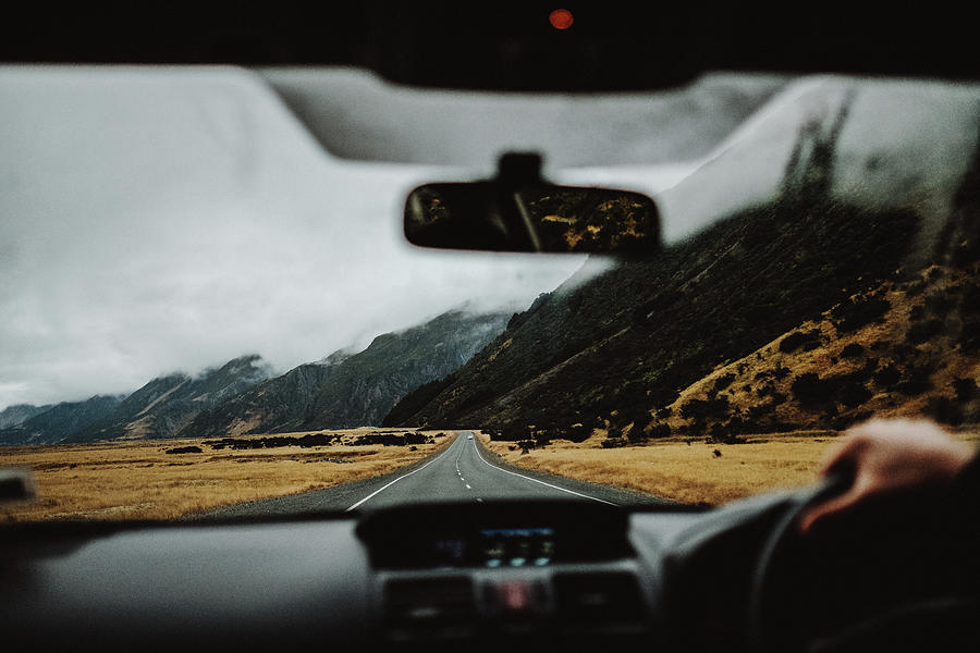 Driving A Car In New Zealand With A Mountain Background In A Moody Day ...