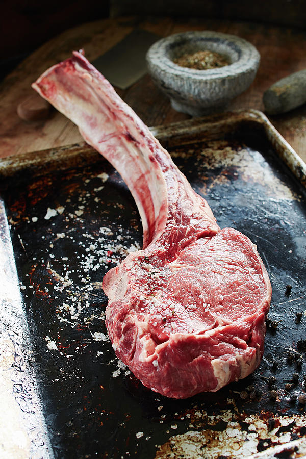 Dry-aged Tomahawk Steak On A Baking Tray Photograph by Rafael Pranschke