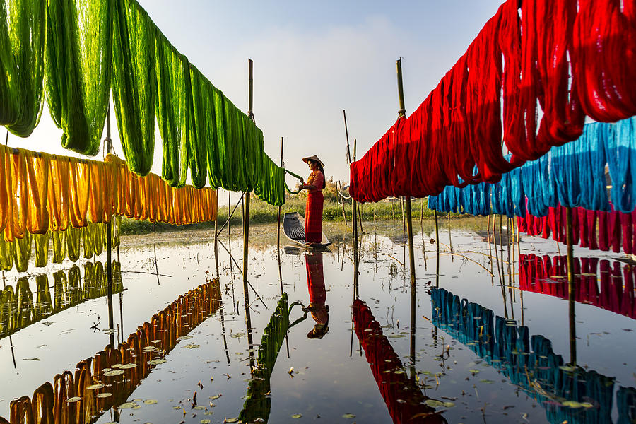 Boat Photograph - Drying Dyed Yarns by Riza Amrullah