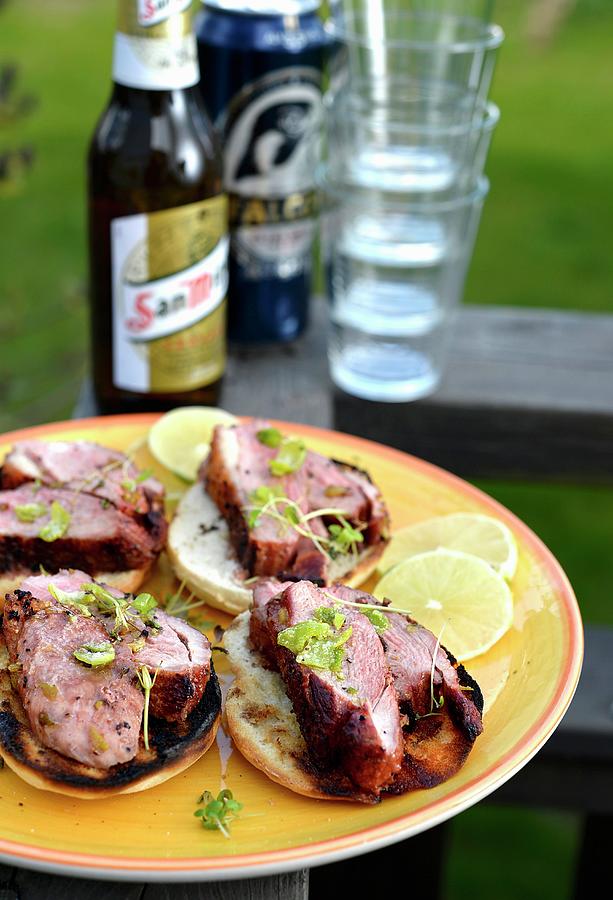 Duck Breast On Slices Of Toast With Beer And Glasses In The Background Photograph by Ian Blasshofer