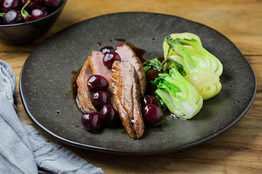 Duck With Sour Cherry Port Wine Sauce And Bok Choy Photograph by Nicole Godt
