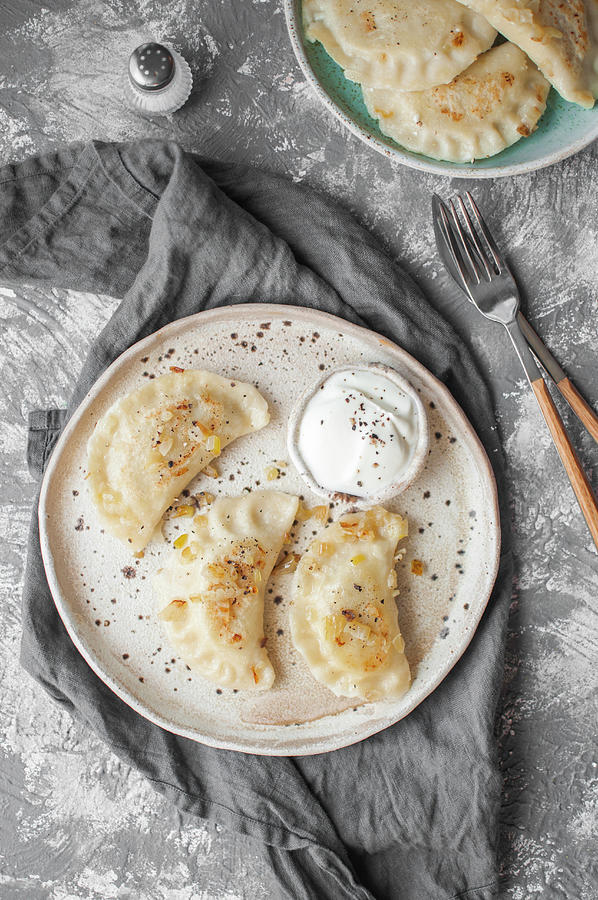 Dumplings With Potatoes, Cottage Cheese And Fried Onion pierogi Ruskie, Served With Sour Cream Photograph by Kachel Katarzyna