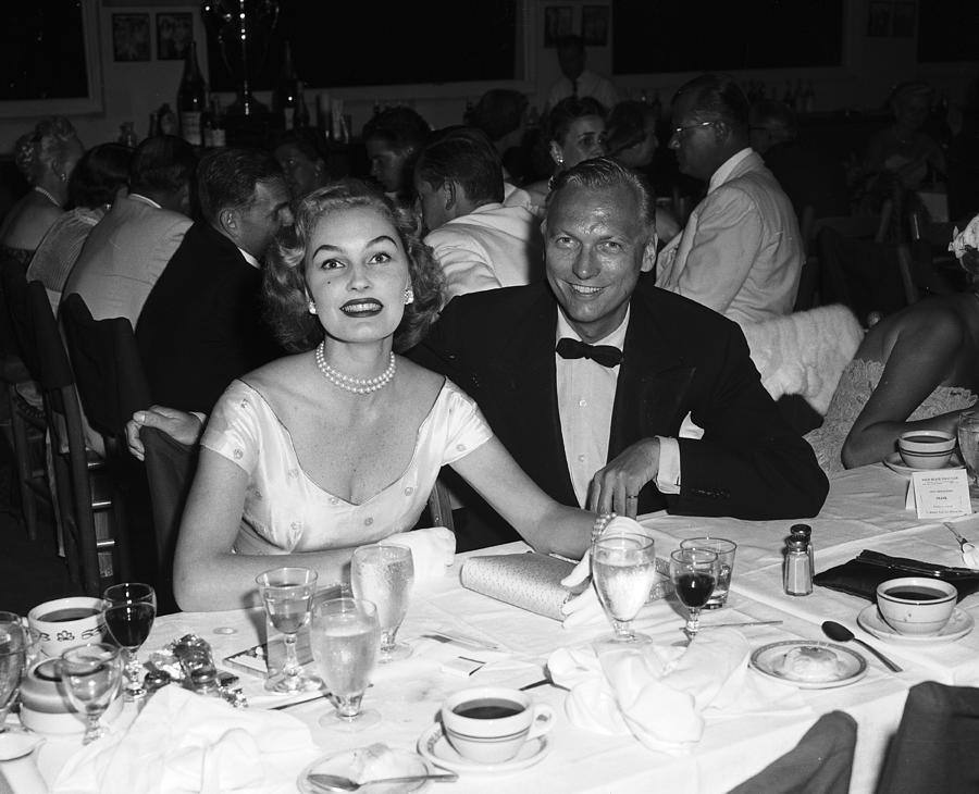 Earl Blackwell And Pamela Curran Seated Photograph by Bert Morgan