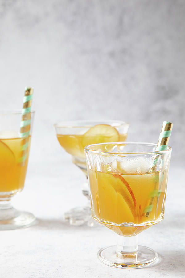 Earl Grey Tea With Apple Slices And Ice Cubes Photograph by Elisabeth Von Plnitz-eisfeld